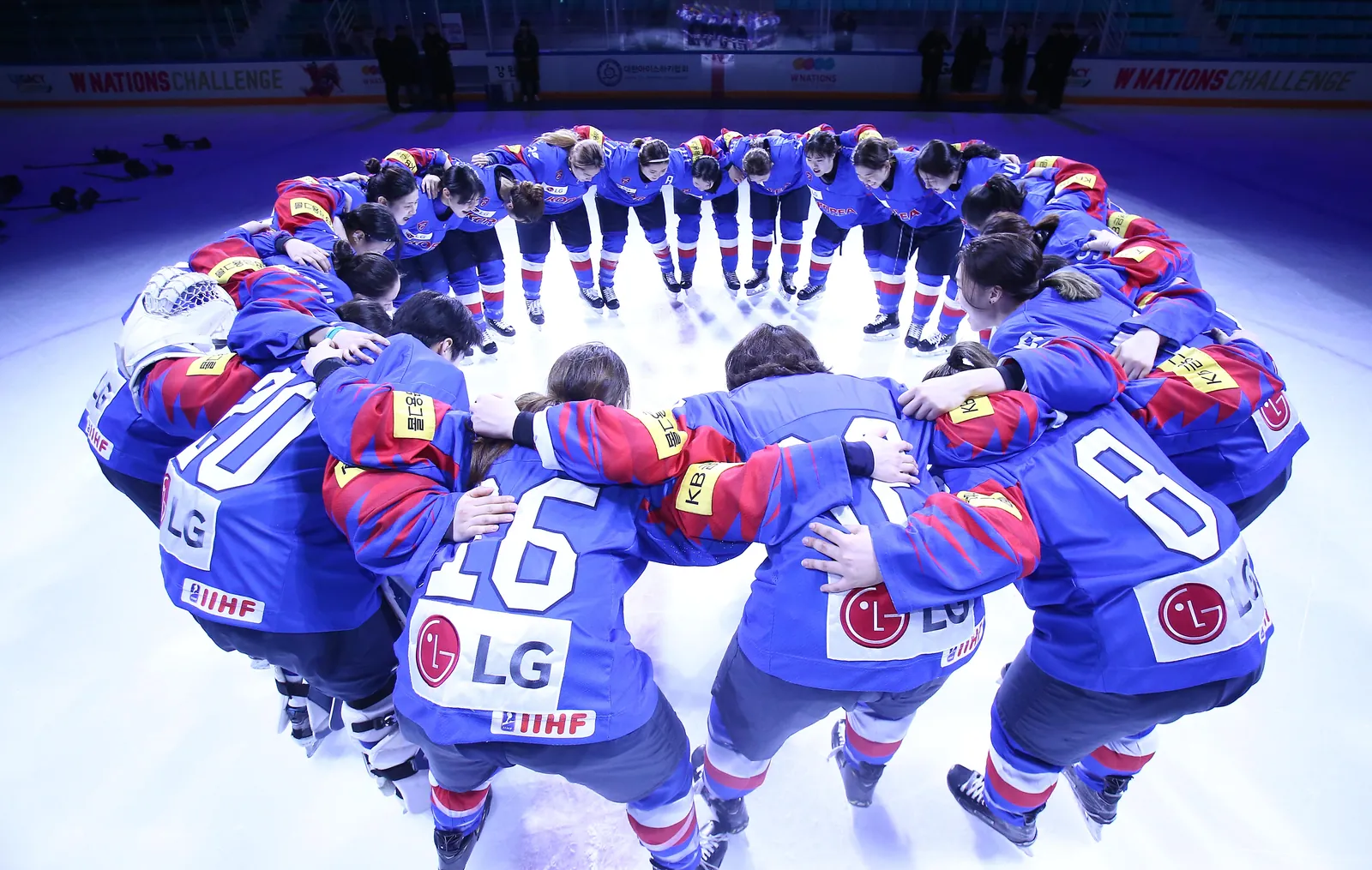 Korea women's national team huddle on the ice