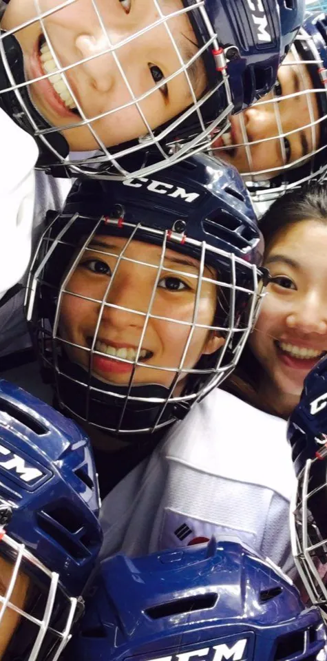 Young players in helmets smiling together