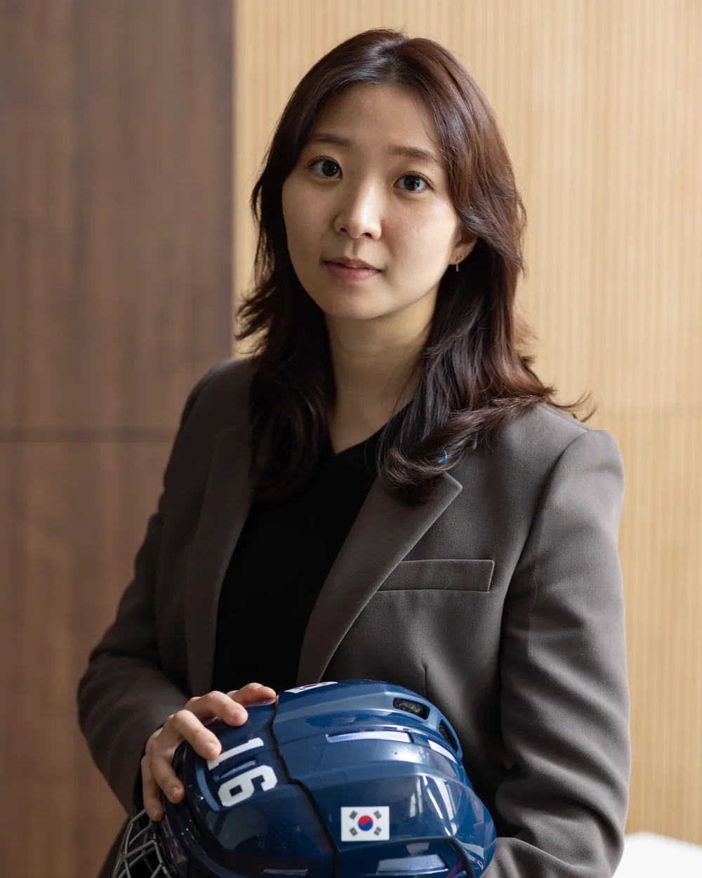 Susie Jo in a blazer holding a Korea helmet