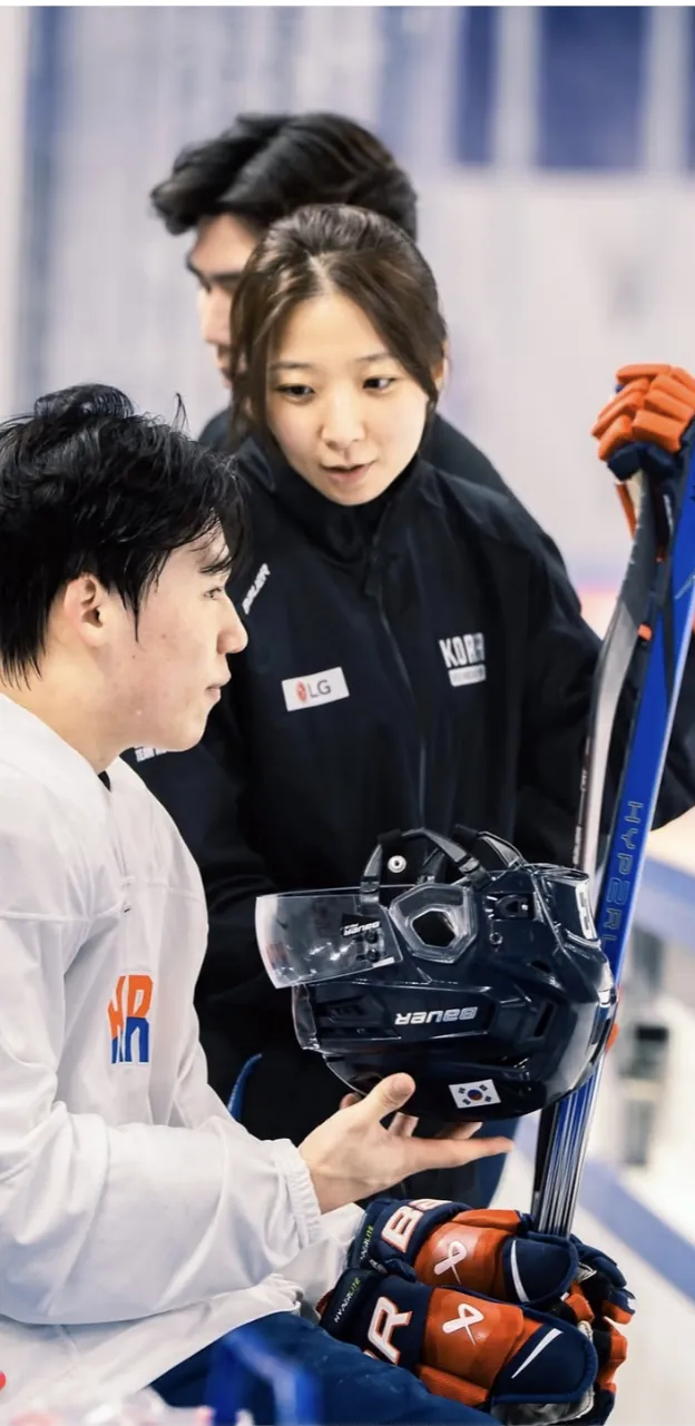 Susie Jo coaching a player at the boards