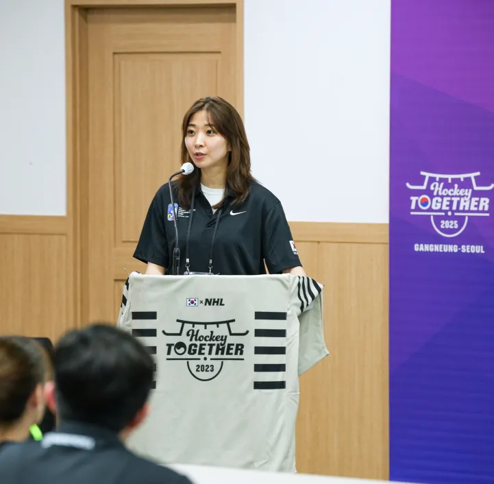 Susie Jo speaking at a Hockey Together event