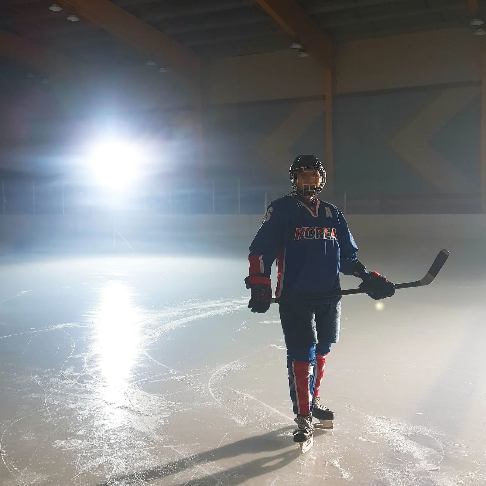Susie Jo alone on the ice under the arena lights