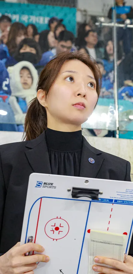 Susie Jo with a tactics board rinkside